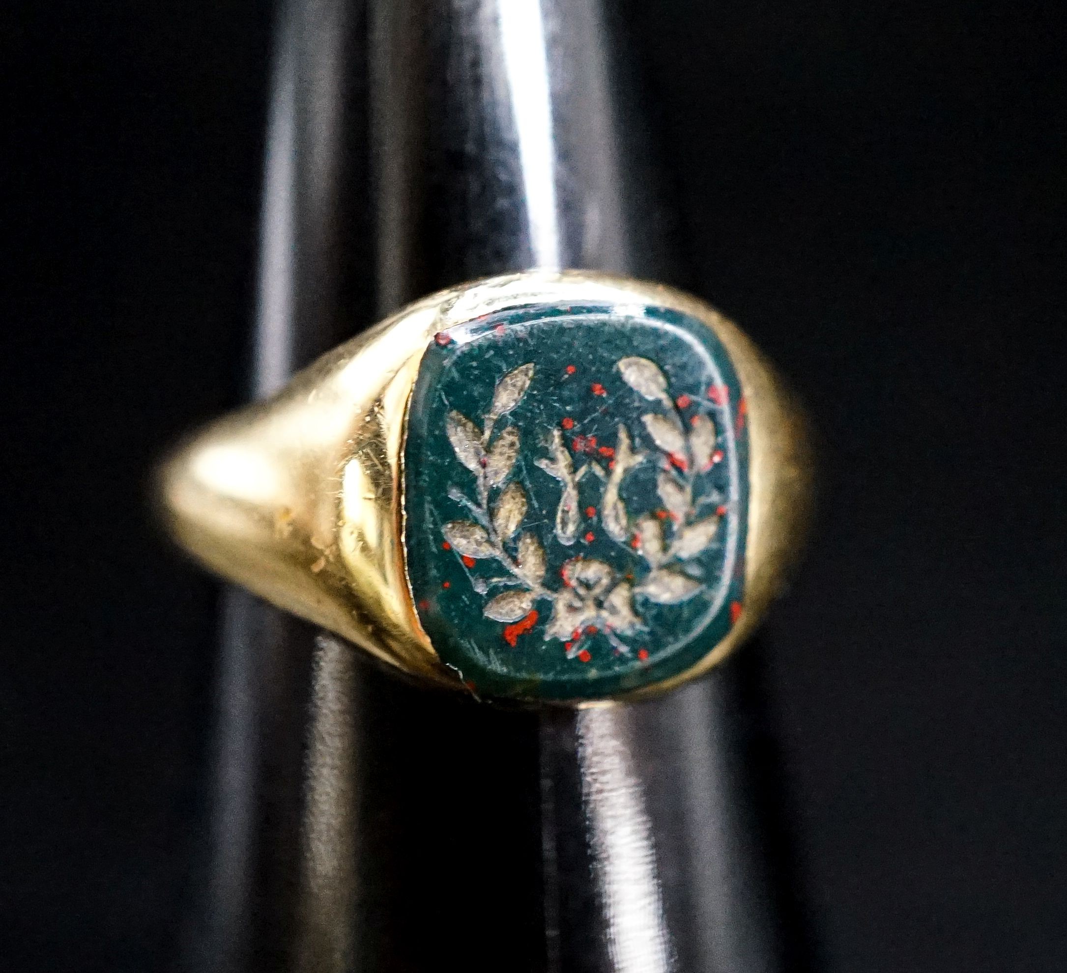A mid 20th century 18ct gold and carved bloodstone set signet ring, size N, gross 8.3 grams.
